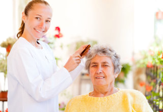 caregiver assisting old woman